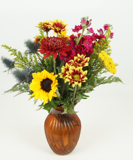 fall-toned flowers in muted orange vase