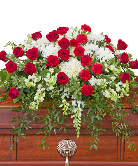 Casket spray of red and white flowers and greenery. 