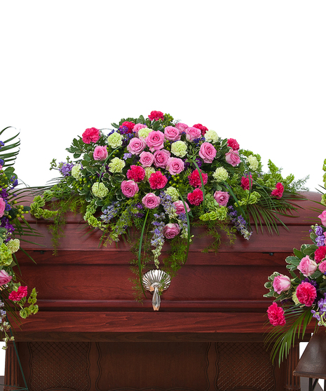 Funeral flower package of a casket spray, standing easel spray and urn arrangement in pink and purple flowers. 