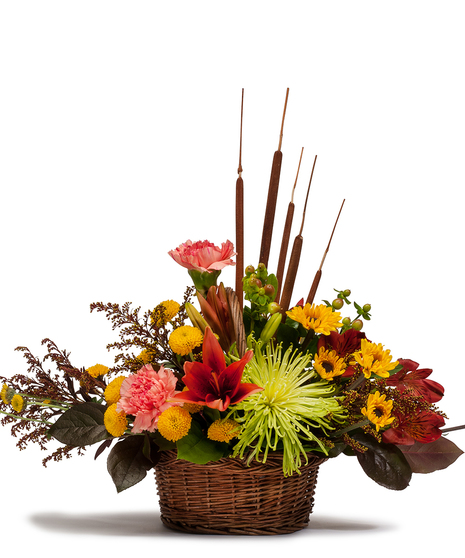 Wicker basket filled with fall flowers. 
