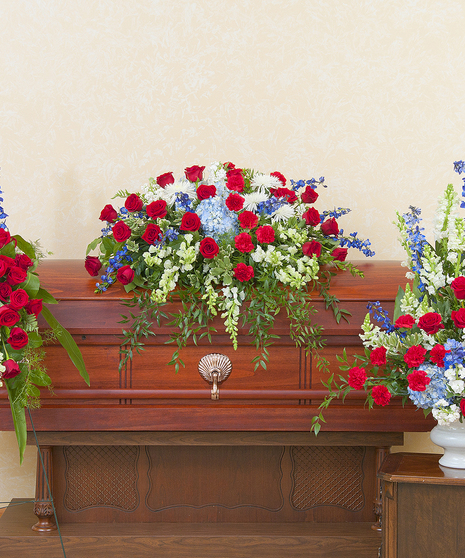 Patriotic casket spray, standing spray, and urn. 