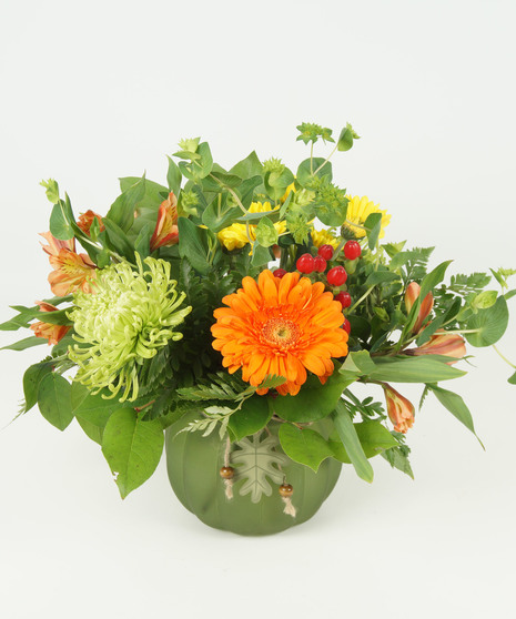 fall toned floral arrangement in pumpkin vase