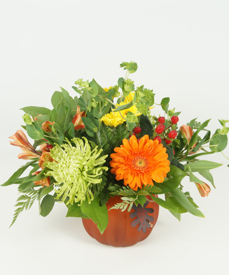 fall toned floral arrangement in pumpkin vase