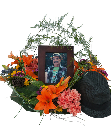 Sympathy wreath of lilies and foliage for a photo frame or urn. 