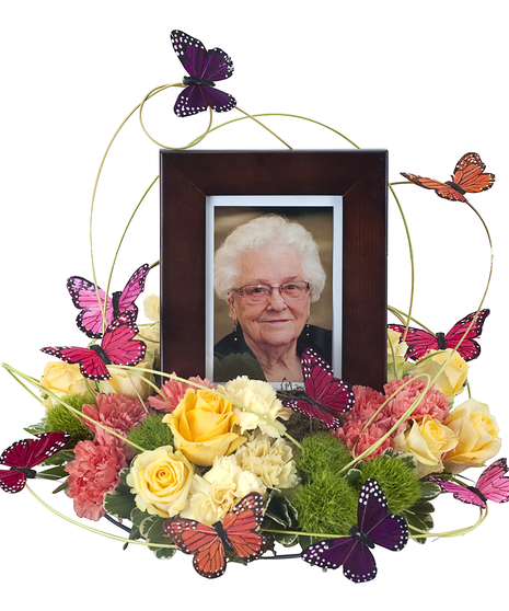 Sympathy wreath of bright flowes and butterfly decorations for surrounding a photo frame or urn. 