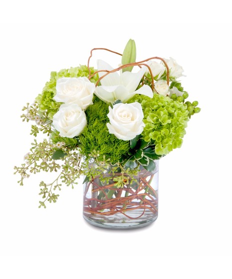 Lilies, roses and hydrangea with curly willow in a clear glass vase.