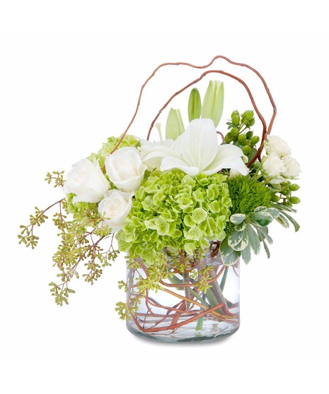 Lilies, roses and hydrangea with curly willow in a clear glass vase.