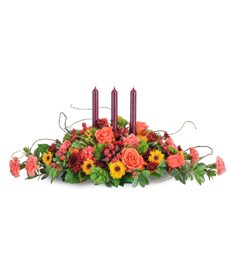 Fall centerpiece of taper candles, roses, carnations, berries and mums. 