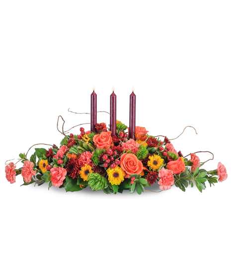 Fall centerpiece of taper candles, roses, carnations, berries and mums. 