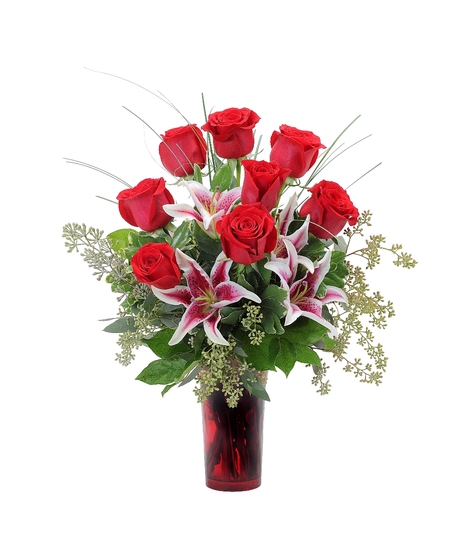 Red roses & lilies in a red vase.