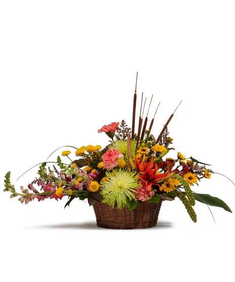 Wicker basket filled with fall flowers. 