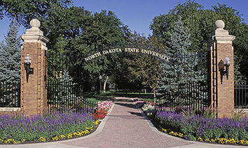 Two brick pillars support a curved 