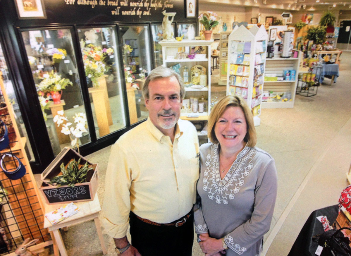 The Shotwell family stands before several lovely bouquets, chilling in our walk-up cooler
